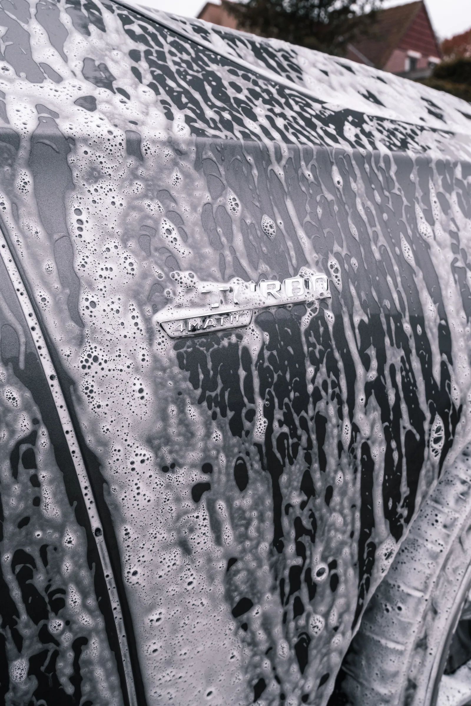 Soap foam running down the side of a car